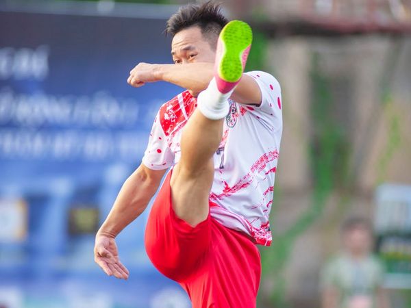 A man mid-exercise, showing concentration and precise movement.